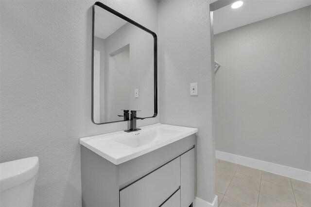 bathroom featuring tile patterned floors, vanity, and toilet