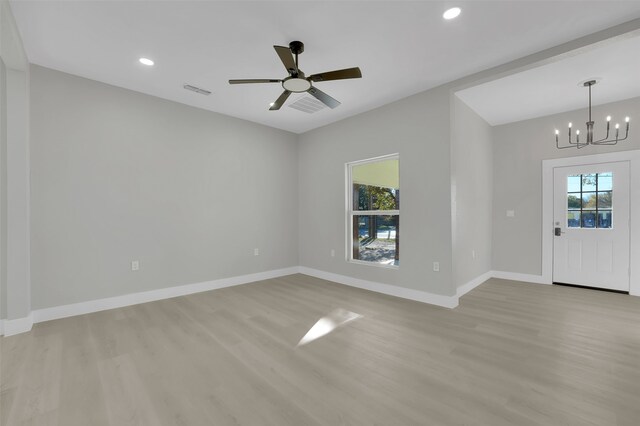 entryway featuring ceiling fan with notable chandelier and light wood-type flooring