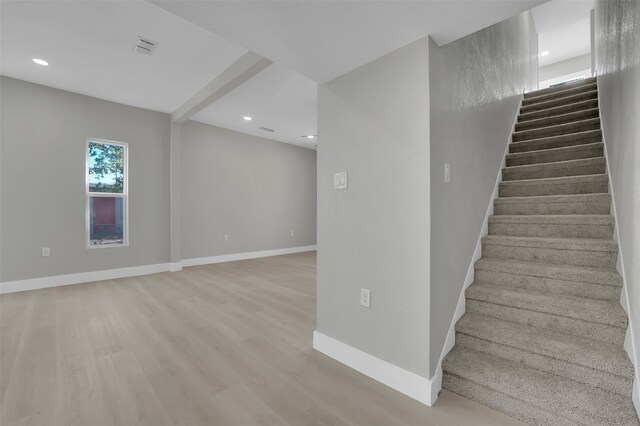 stairway with hardwood / wood-style flooring