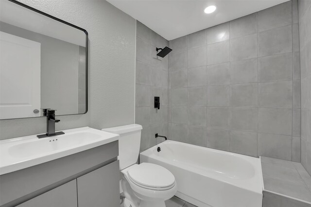 full bathroom featuring vanity, toilet, and tiled shower / bath