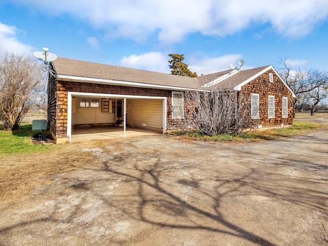 view of side of home with a carport