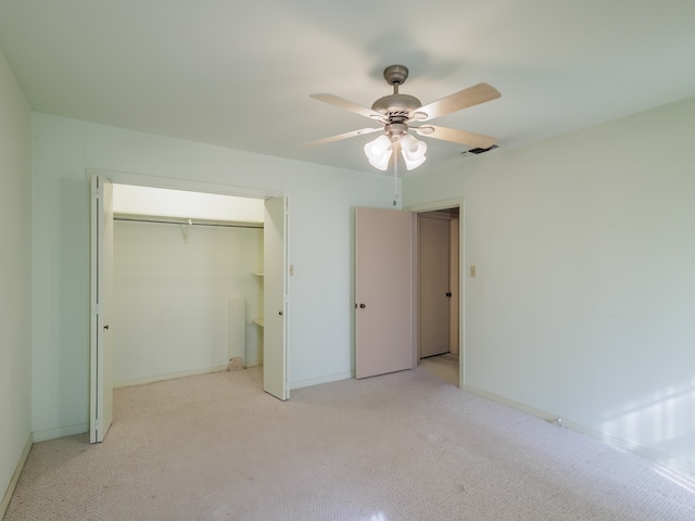 unfurnished bedroom featuring ceiling fan, light colored carpet, and a closet