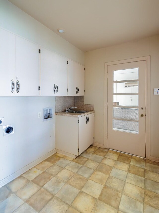 laundry area featuring cabinets, hookup for a washing machine, hookup for an electric dryer, and sink