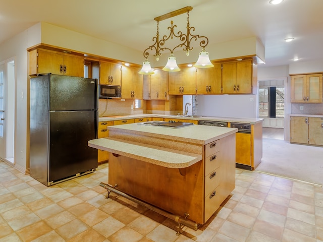 kitchen with a center island, sink, pendant lighting, decorative backsplash, and black appliances