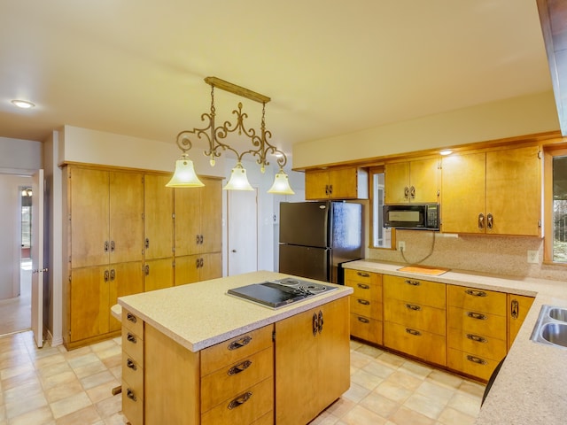 kitchen with decorative backsplash, electric stovetop, a center island, stainless steel refrigerator, and hanging light fixtures