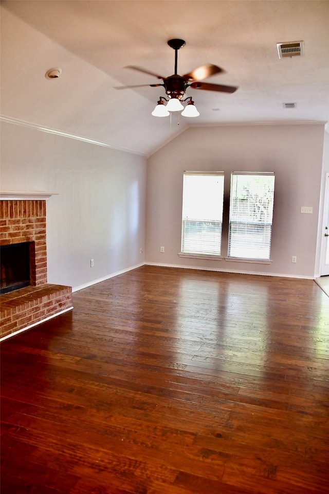 unfurnished living room with a fireplace, dark hardwood / wood-style floors, vaulted ceiling, and ceiling fan