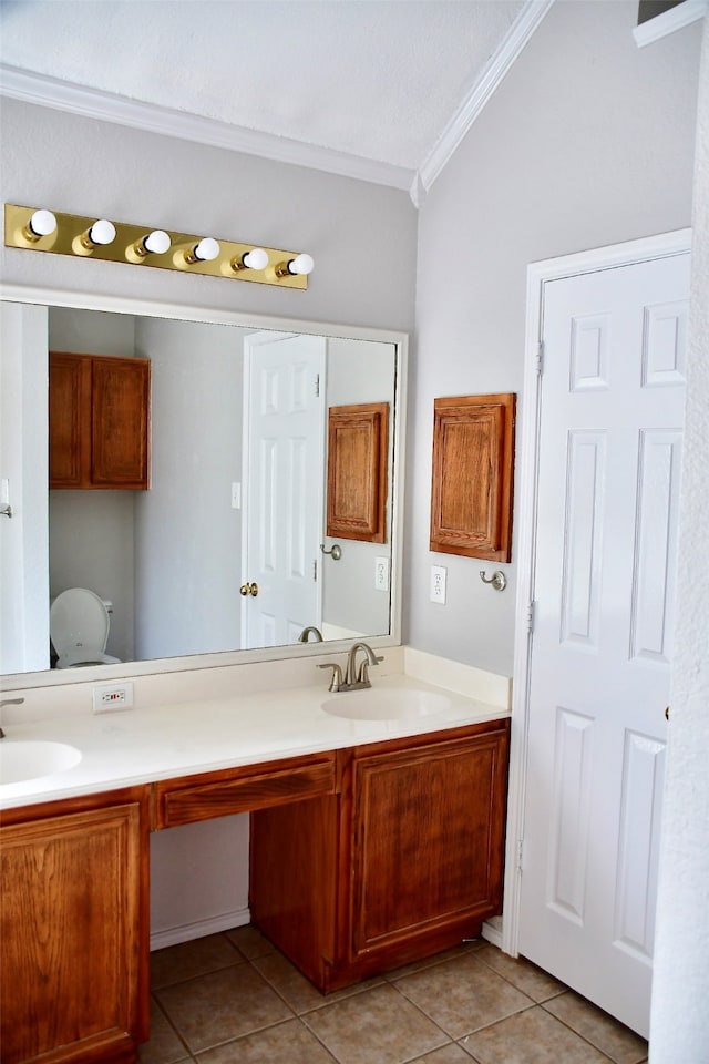 bathroom with crown molding, tile patterned flooring, vanity, and vaulted ceiling