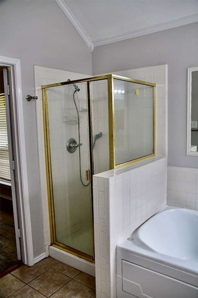 bathroom featuring tile patterned flooring, shower with separate bathtub, crown molding, and vaulted ceiling