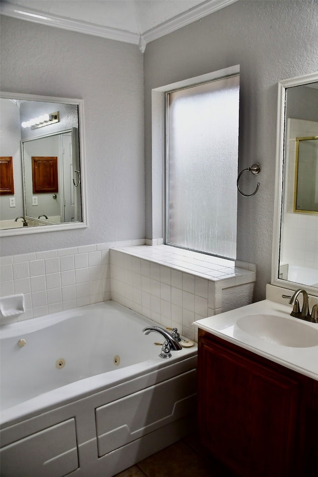 bathroom featuring a bathing tub, vanity, and ornamental molding