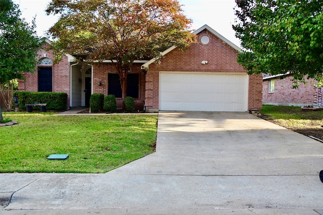 view of front of property featuring a front yard and a garage