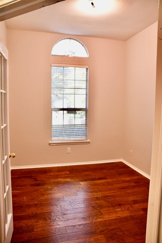 empty room featuring dark wood-type flooring