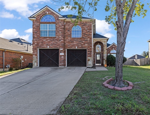 view of property featuring a garage and a front yard