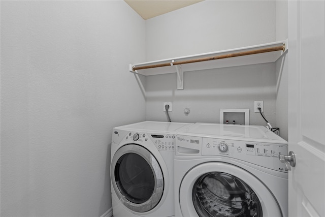 clothes washing area featuring washer and clothes dryer