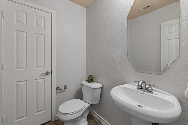 bathroom featuring toilet and sink