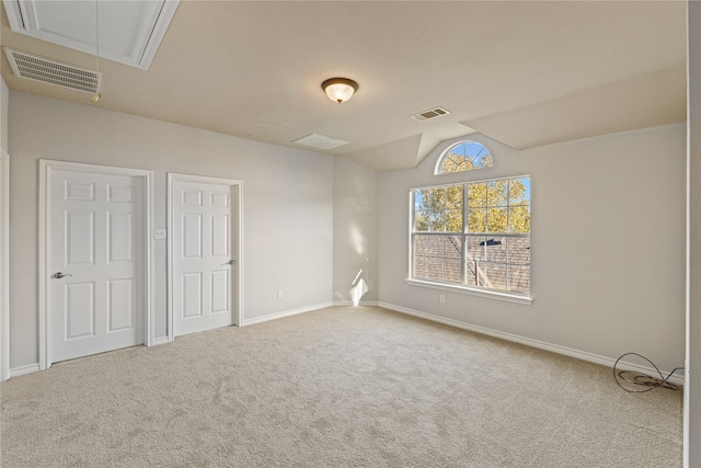 unfurnished bedroom with carpet and vaulted ceiling