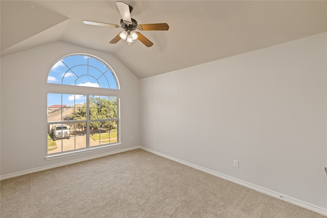 carpeted empty room with ceiling fan and lofted ceiling