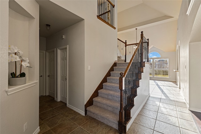 stairway featuring a high ceiling