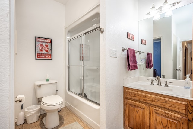 full bathroom with vanity, combined bath / shower with glass door, and toilet