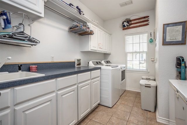 clothes washing area featuring cabinets, light tile patterned floors, independent washer and dryer, and sink