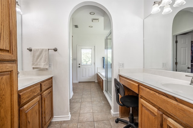 bathroom featuring tile patterned flooring, vanity, and shower with separate bathtub