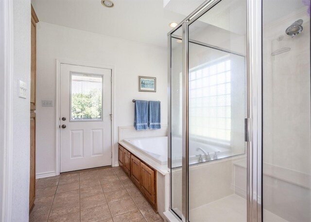 bathroom featuring tile patterned flooring and separate shower and tub