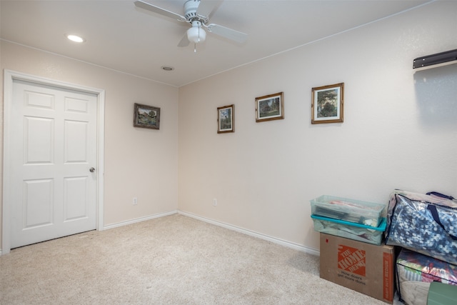 interior space with ceiling fan and light colored carpet