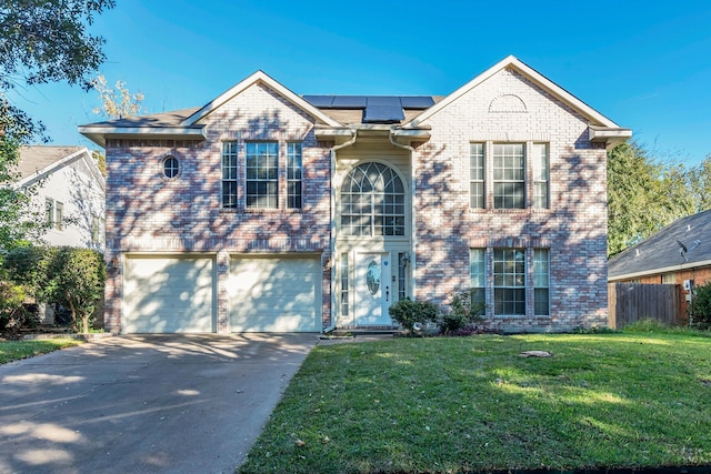 front of property featuring solar panels, a garage, and a front yard