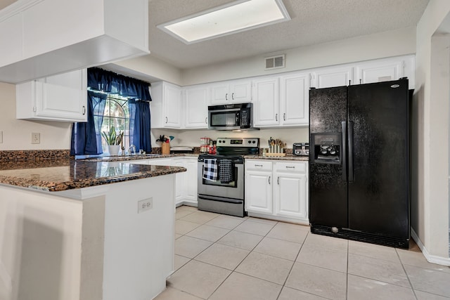 kitchen featuring black appliances, white cabinets, dark stone countertops, light tile patterned floors, and kitchen peninsula