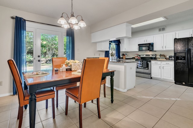 dining space featuring light tile patterned floors and a chandelier