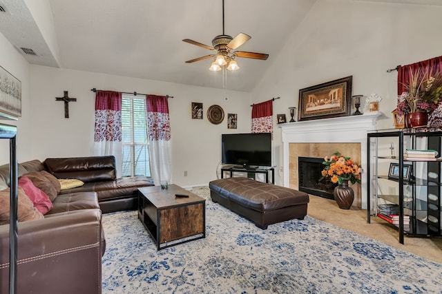 living room featuring ceiling fan, light colored carpet, a fireplace, and high vaulted ceiling