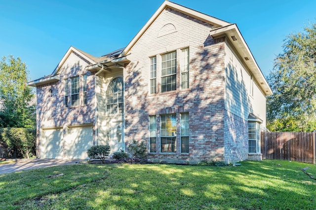 view of front of home featuring a front lawn and a garage