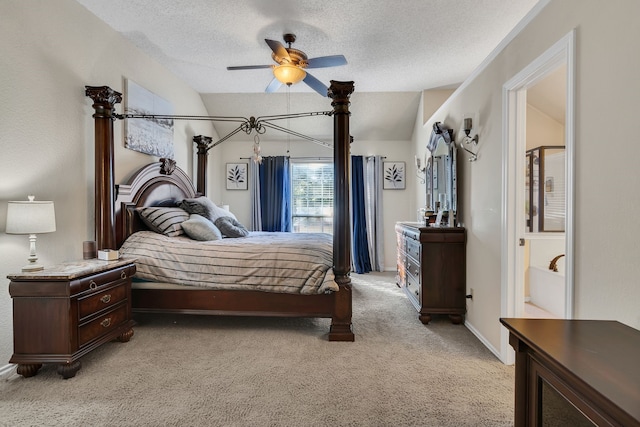 bedroom featuring lofted ceiling, ceiling fan, light colored carpet, and a textured ceiling