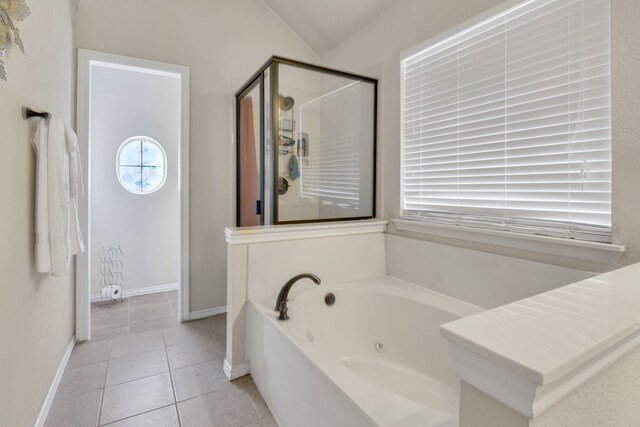 bathroom featuring a tub, tile patterned flooring, and vanity