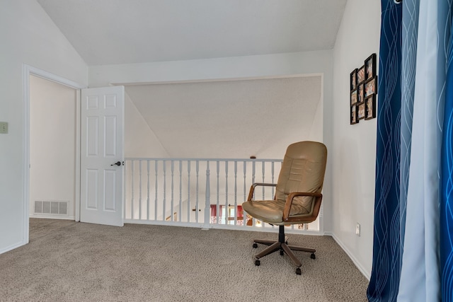 sitting room featuring carpet floors and vaulted ceiling