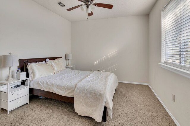 bedroom featuring ceiling fan, carpet floors, and a textured ceiling