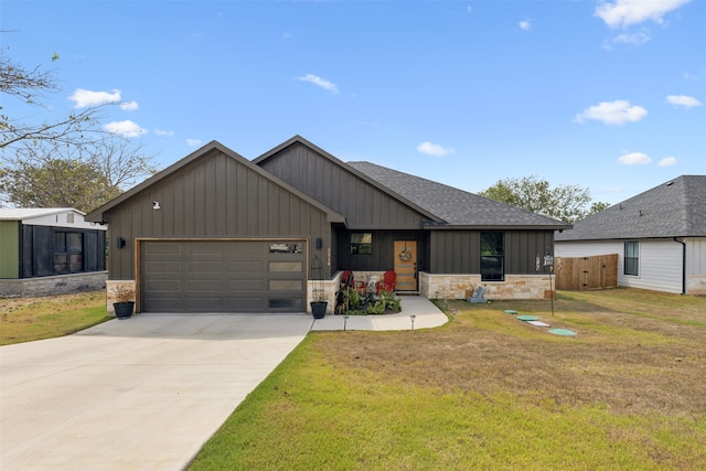 view of front of property with a front yard and a garage