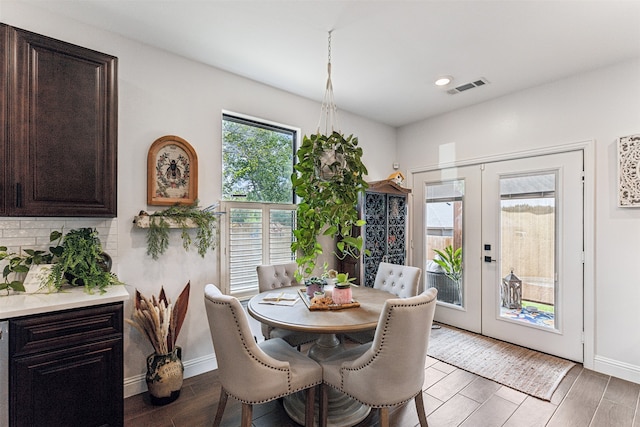 dining room featuring french doors and dark wood-type flooring