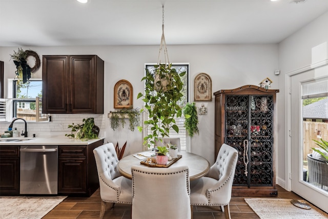 dining space with dark hardwood / wood-style floors and sink