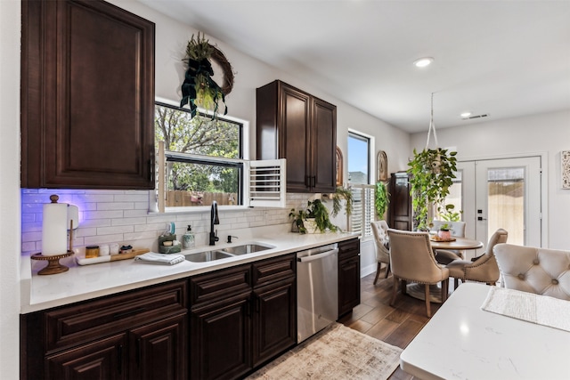 kitchen featuring french doors, sink, stainless steel dishwasher, dark hardwood / wood-style floors, and backsplash