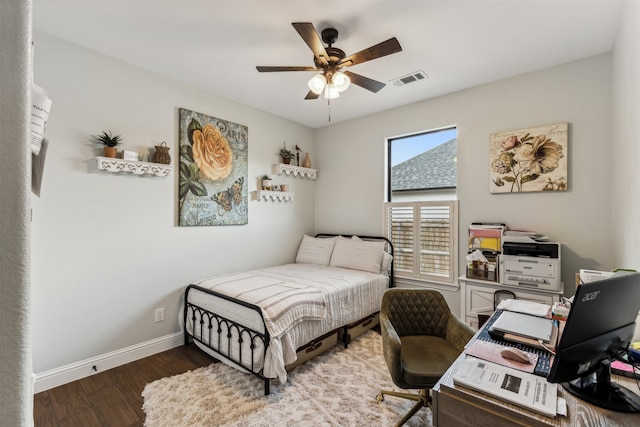 bedroom with ceiling fan and dark hardwood / wood-style flooring