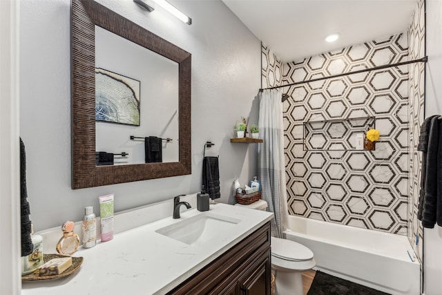 full bathroom with vanity, shower / tub combo, and toilet