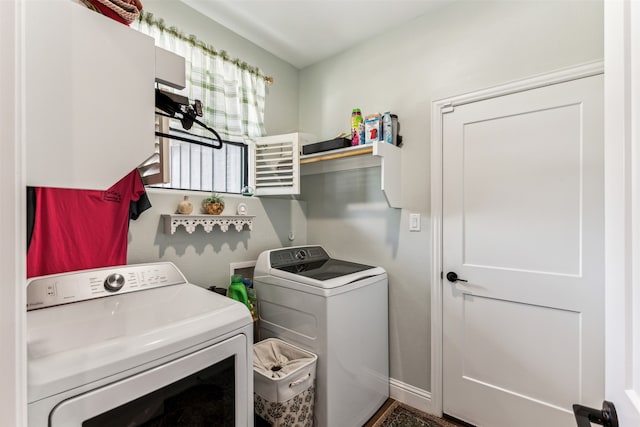 clothes washing area with washing machine and clothes dryer