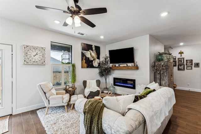 living room with ceiling fan and dark wood-type flooring