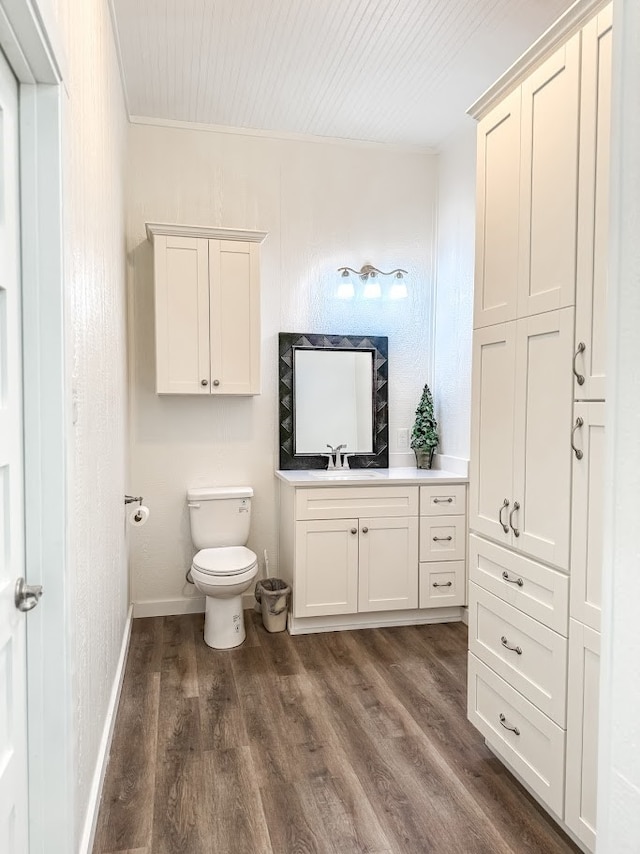 bathroom with hardwood / wood-style flooring, vanity, and toilet