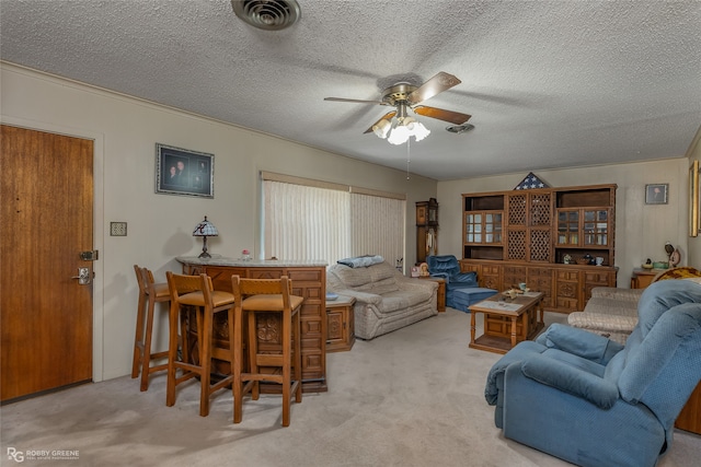 living room with light carpet, a textured ceiling, and ceiling fan