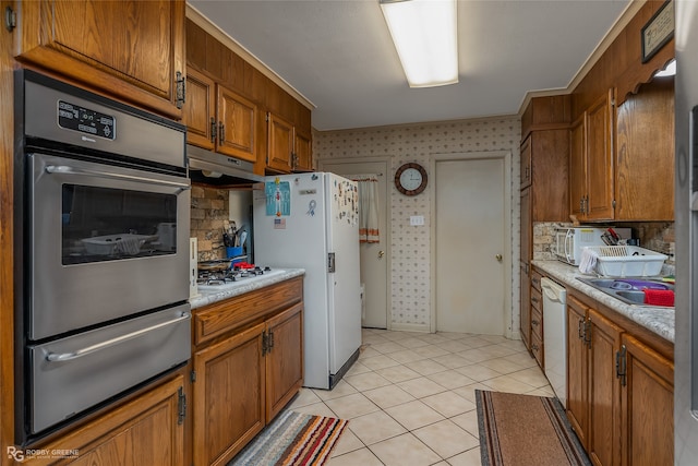 kitchen featuring light tile patterned flooring and stainless steel appliances