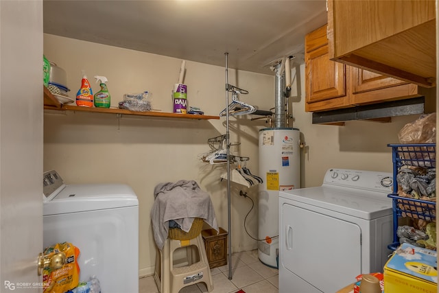 laundry room featuring cabinets, light tile patterned floors, washing machine and dryer, and gas water heater