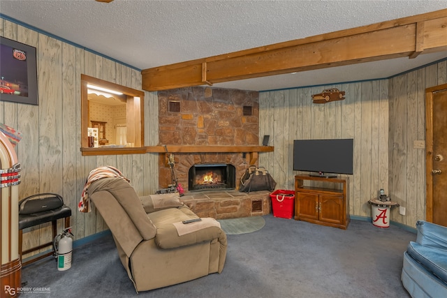 living room with beamed ceiling, wood walls, carpet floors, a textured ceiling, and a fireplace