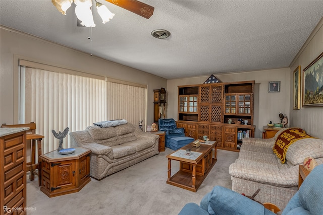 carpeted living room with ceiling fan and a textured ceiling