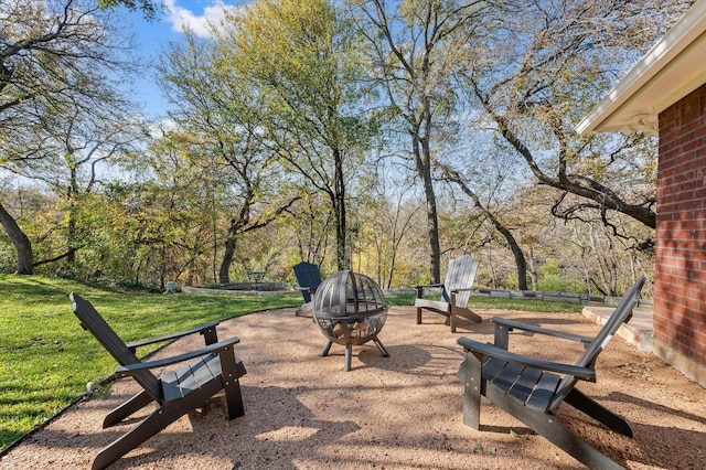 view of home's community with a yard and a fire pit